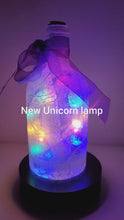 Load and play video in Gallery viewer, Rotating example of a Lit up Gin bottle with Unicorn detail. Rainbow coloured bow

