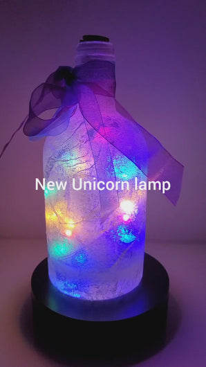 Rotating example of a Lit up Gin bottle with Unicorn detail. Rainbow coloured bow