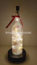 Load and play video in Gallery viewer, Rotating example of a Lit up wine bottle with wild animal detail. Red Bow
