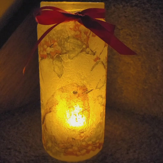 Rotaing lit up glass jar with robin detail. Red bow