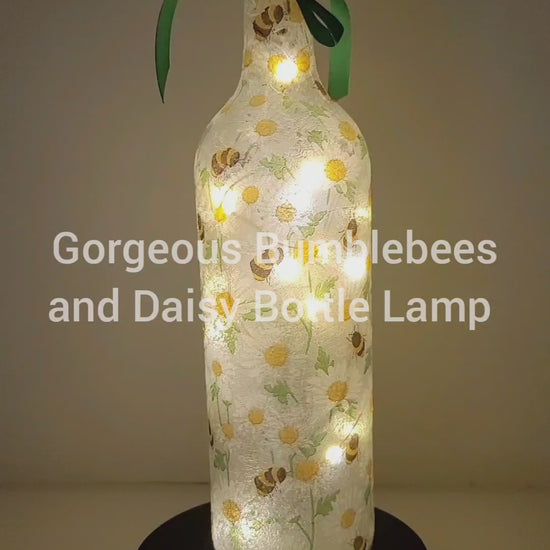 Rotating Lit up wine bottle with Bumble bee and Daisy detailing. Green bow