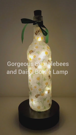 Rotating Lit up wine bottle with Bumble bee and Daisy detailing. Green bow