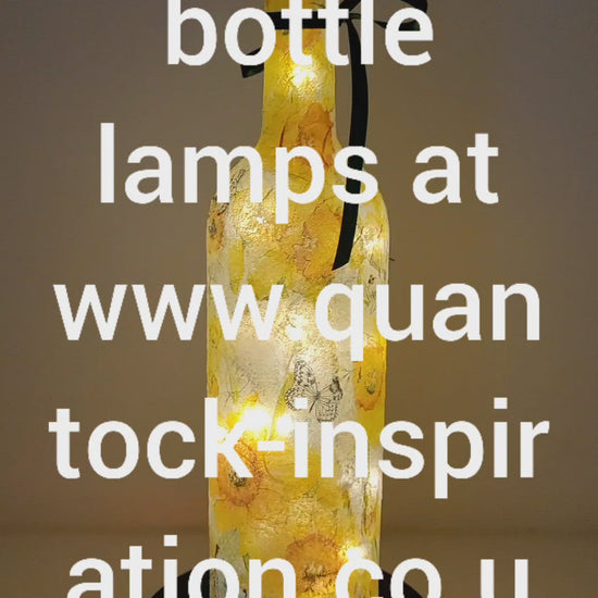 Lit up wine bottle with Daffodil design. Green Bow around the neck