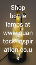 Load and play video in Gallery viewer, Lit up wine bottle with Daffodil design. Green Bow around the neck
