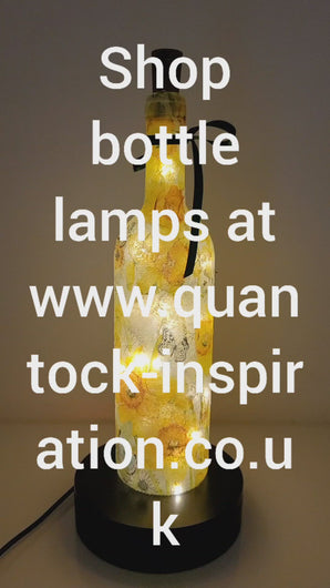 Lit up wine bottle with Daffodil design. Green Bow around the neck