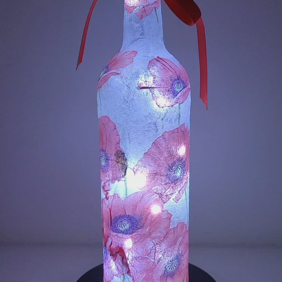 Rotating Lit up wine bottle with Poppy detail. Red Bow