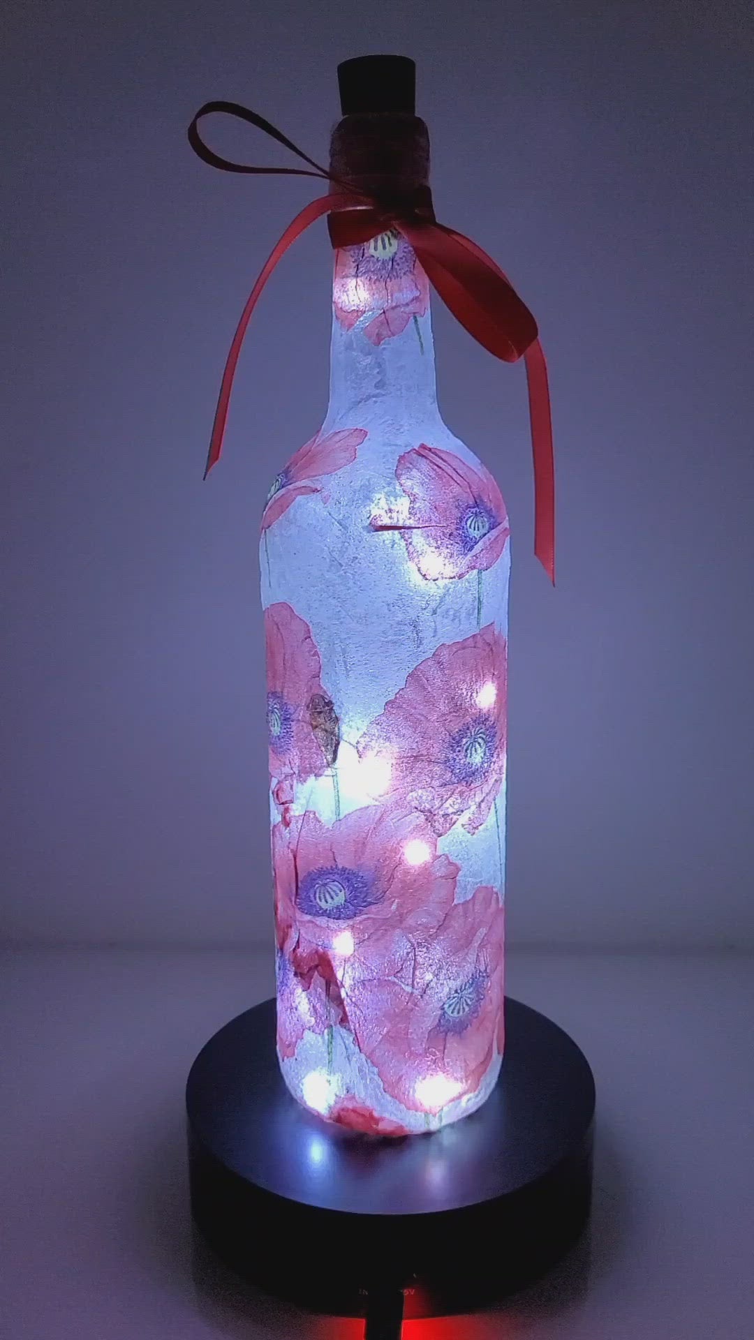 Rotating Lit up wine bottle with Poppy detail. Red Bow