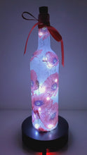 Load and play video in Gallery viewer, Rotating Lit up wine bottle with Poppy detail. Red Bow
